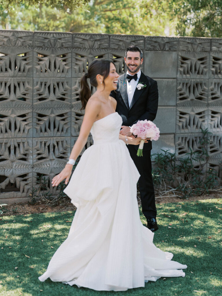 Bride twirls in elegant gown during candid wedding moment