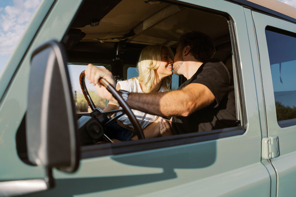 Romantic Arizona engagement photographer couple kissing in Land Rover