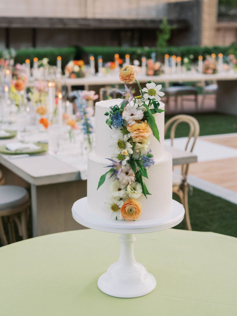 White wedding cake with colorful floral decorations