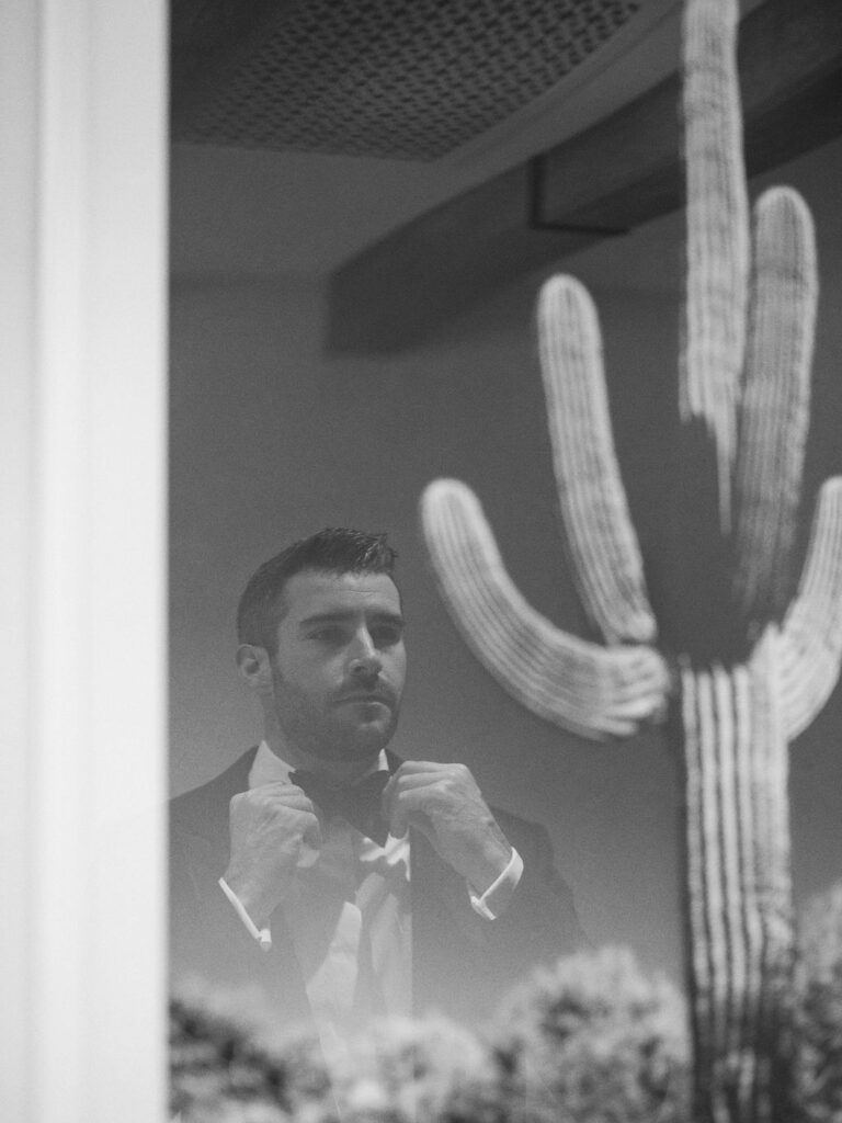 Groom portrait with cactus shadow Arizona editorial wedding