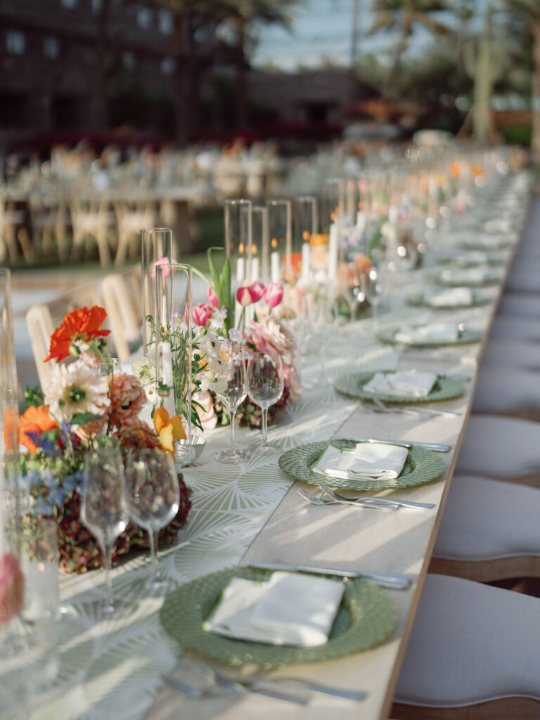 Elegant wedding reception table with colorful florals and modern place settings