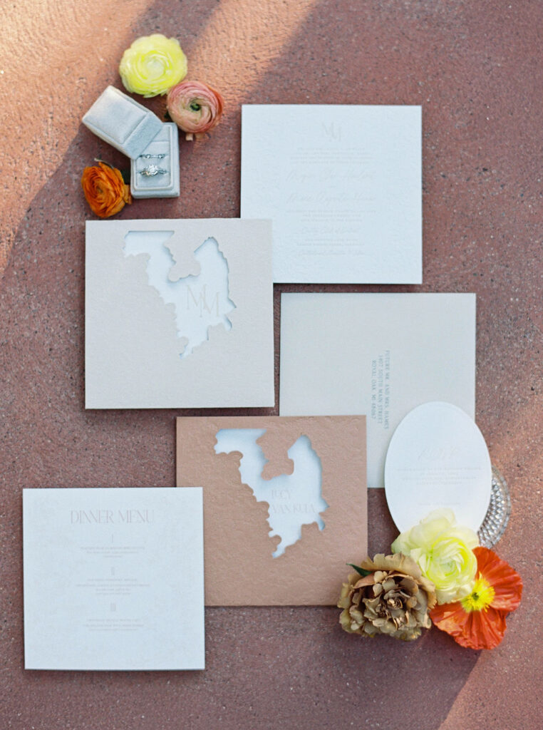 Wedding invitation suite styled with coral and ivory details at El Chorro.