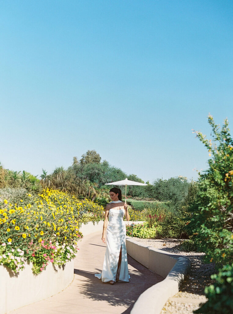 Bride walking through Camelback Inn garden pathway
