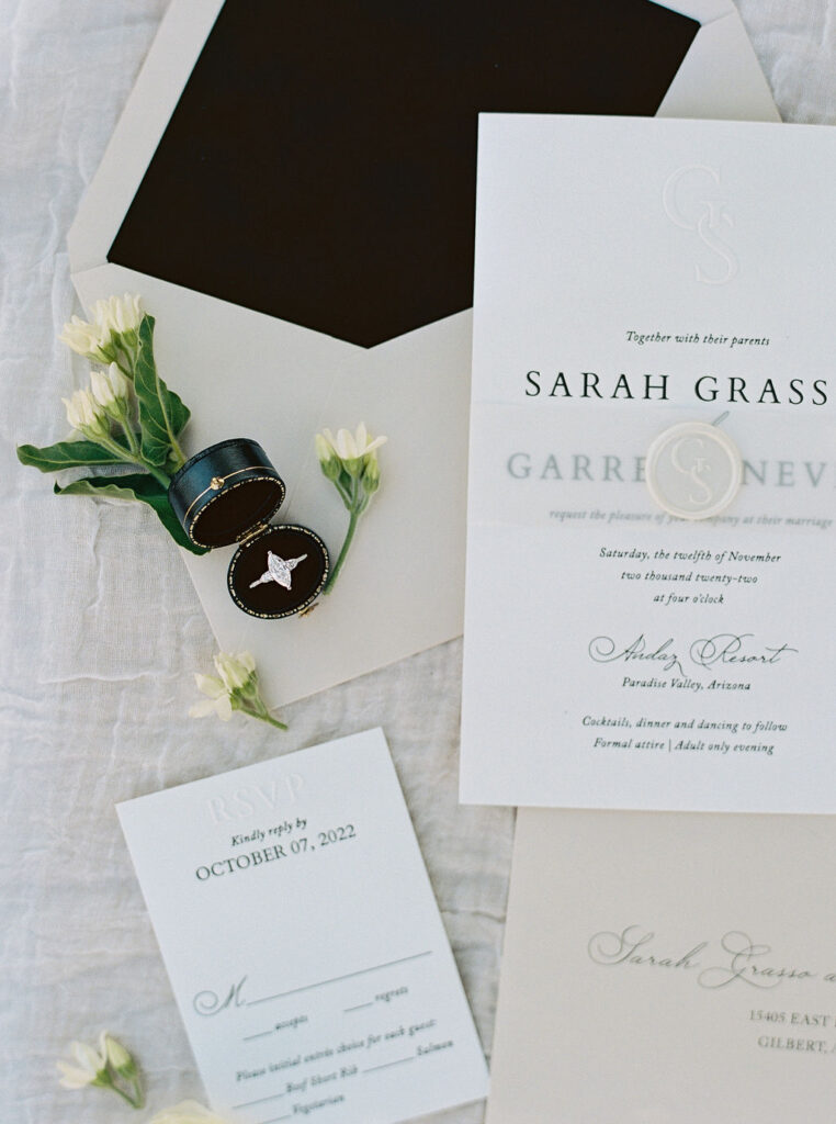 Wedding invitation suite styled with florals and details.