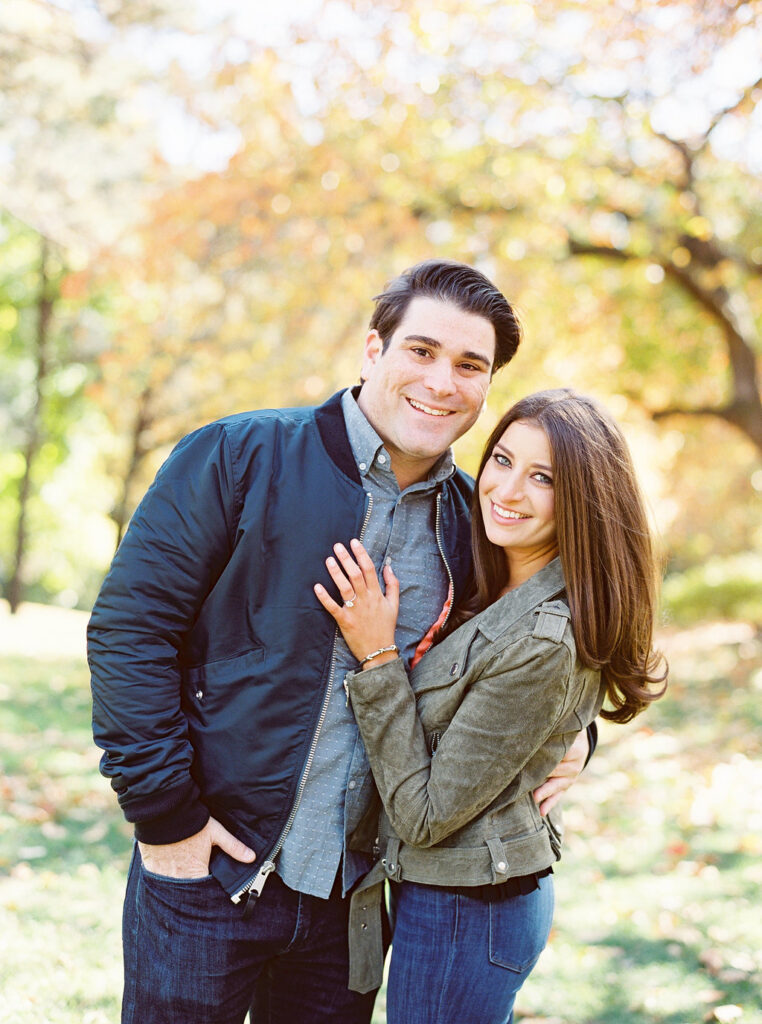 Couple smiling during fall engagement session in Central Park
