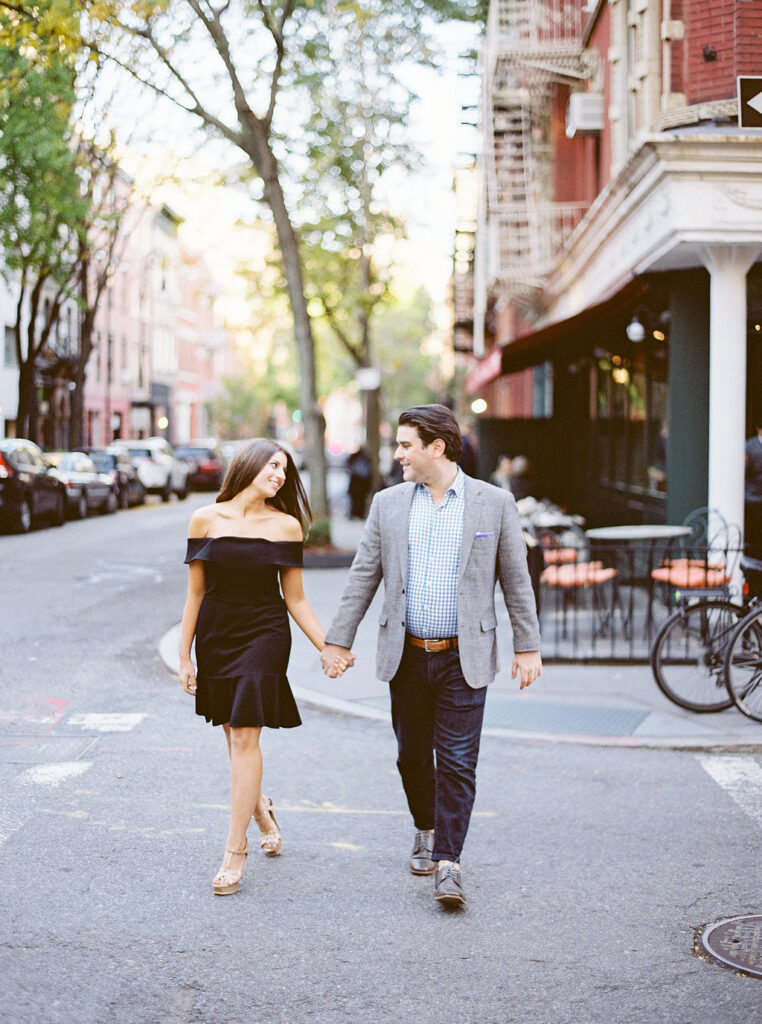 Couple holding hands during NYC engagement session in West Village