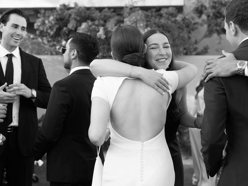 Bride hugging guest during cocktail hour at DC Ranch wedding
