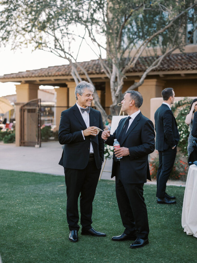 Wedding guests in conversation at cocktail hour DC Ranch