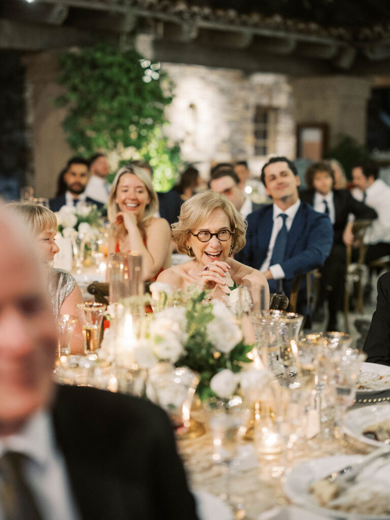 Guests laughing during reception dinner at DC Ranch