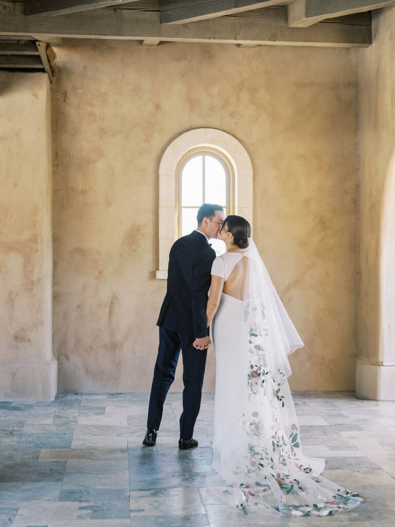 Bride and groom under stone arch at DC Ranch wedding