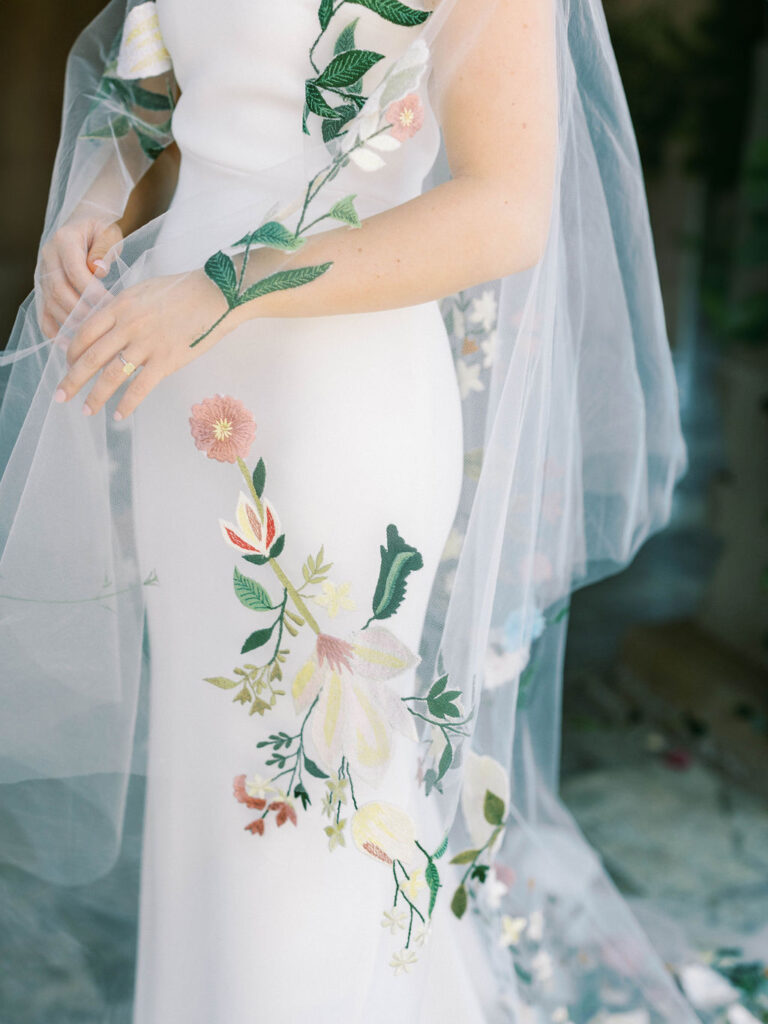 Close-up of bride’s gown with floral embroidery details