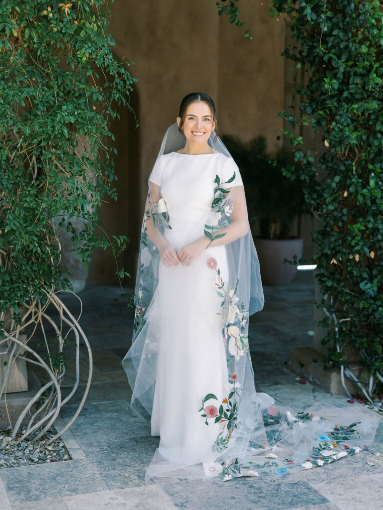 Bride in gown with hand-painted floral details at DC Ranch
