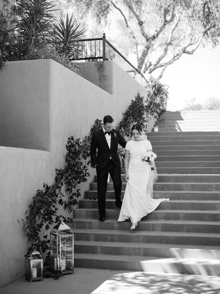 Bride and groom walking down ceremony staircase in Arizona