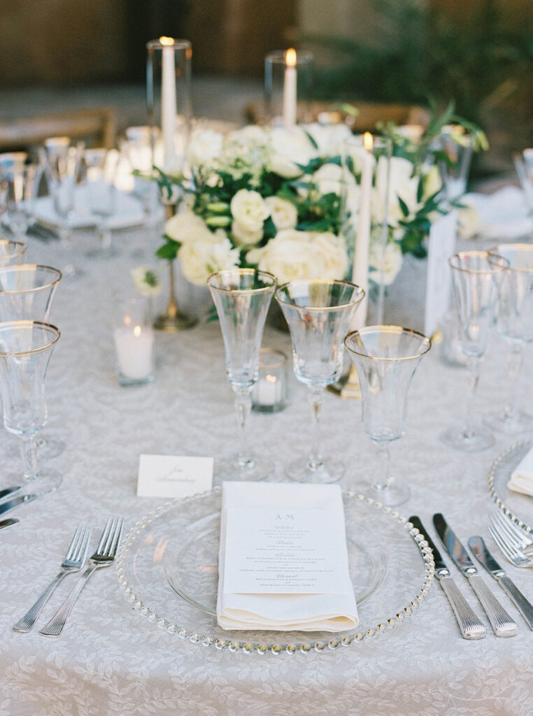 Elegant reception table with white florals and candles at DC Ranch wedding