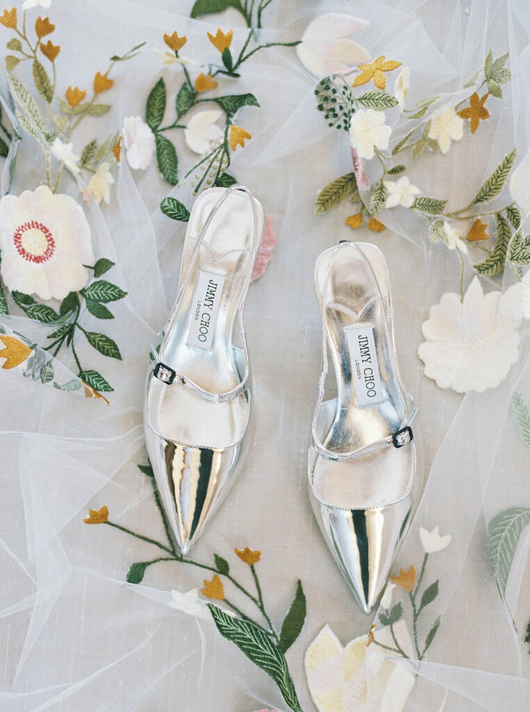 Silver bridal shoes styled on floral wedding veil detail