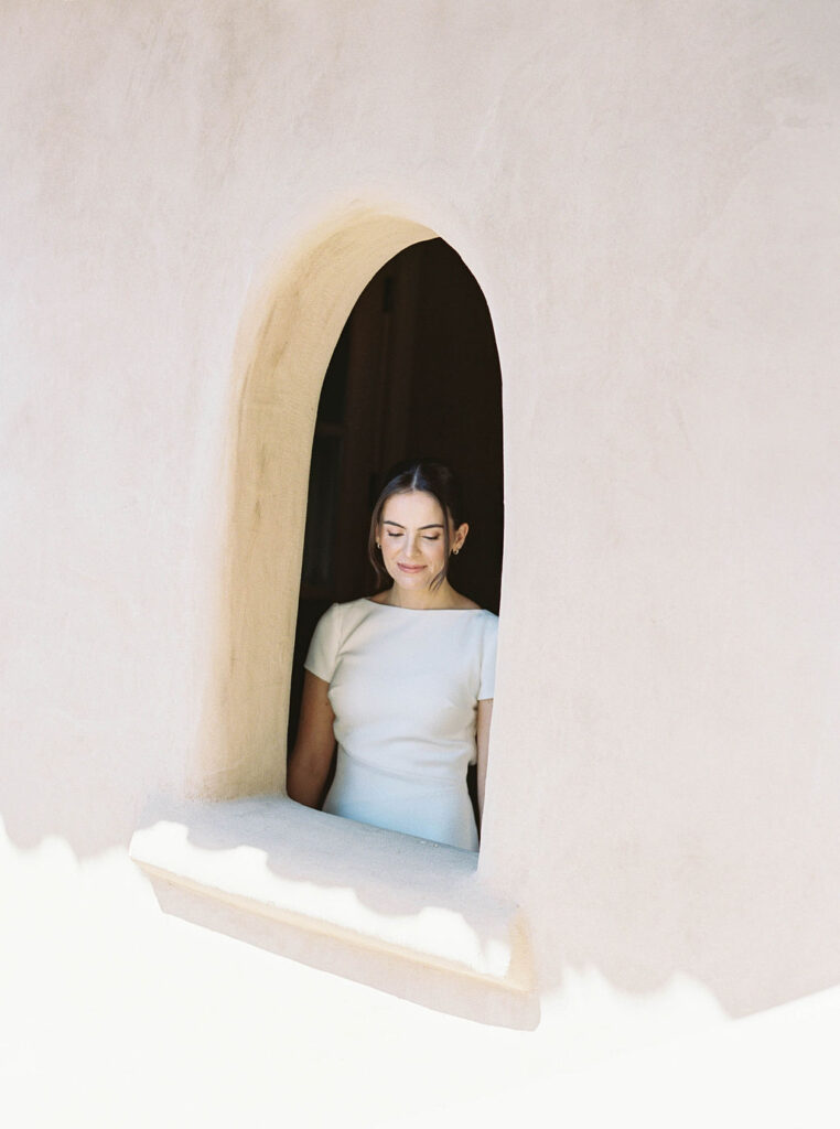 Bride framed in arched window at DC Ranch in Arizona