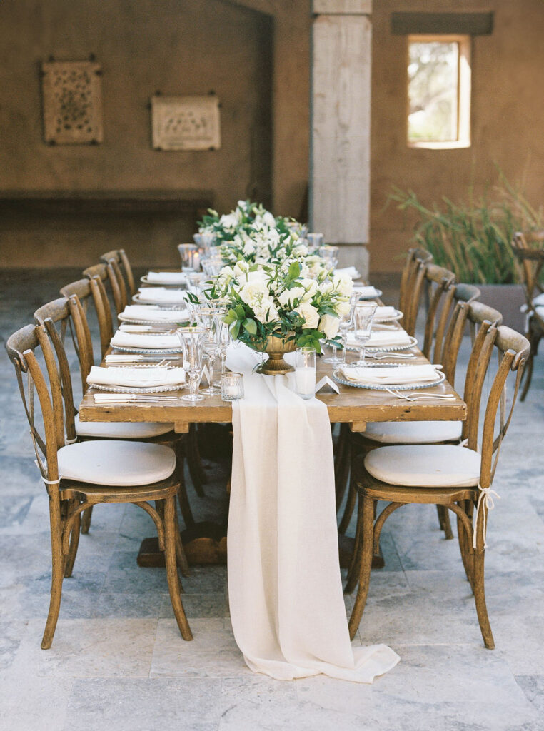 Long reception table with floral centerpieces at DC Ranch wedding
