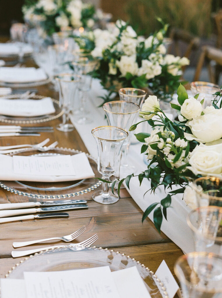 Elegant reception table detail with florals and glassware