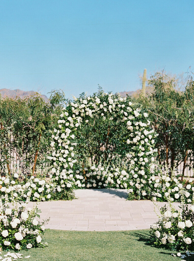 Wedding ceremony floral arch with greenery at DC Ranch