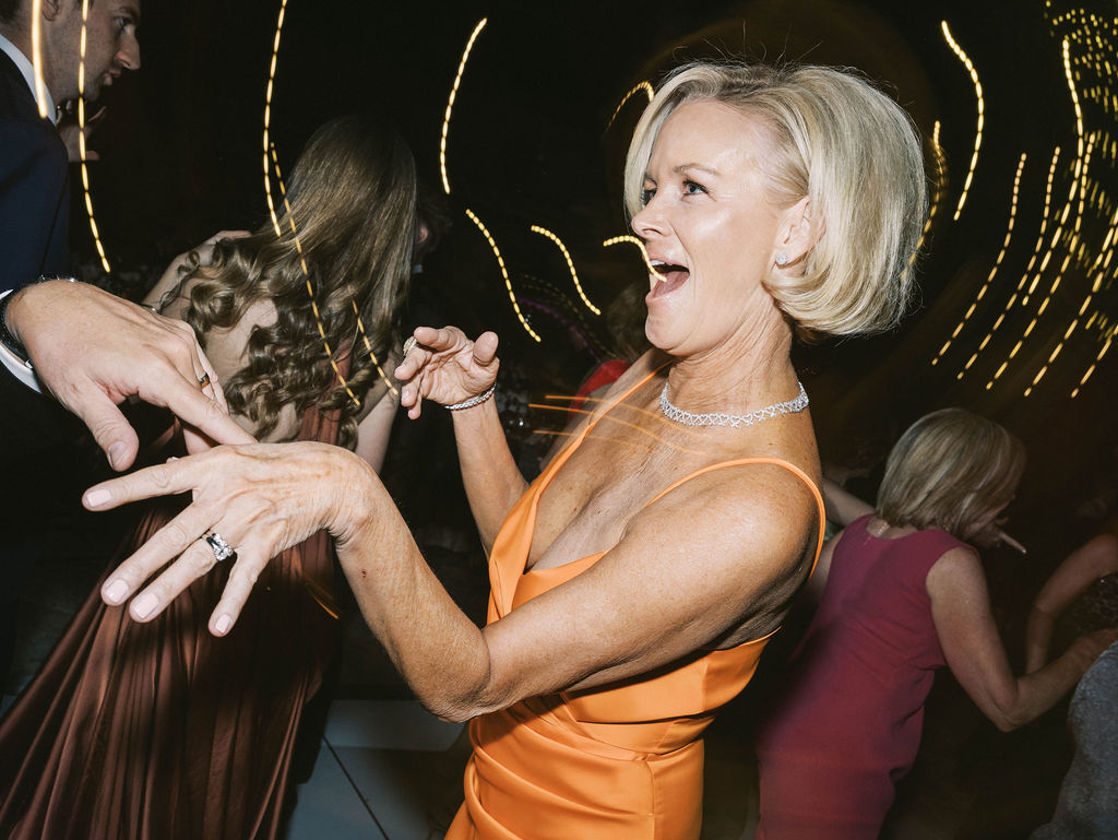 Wedding guest dancing joyfully at DC Ranch reception Arizona