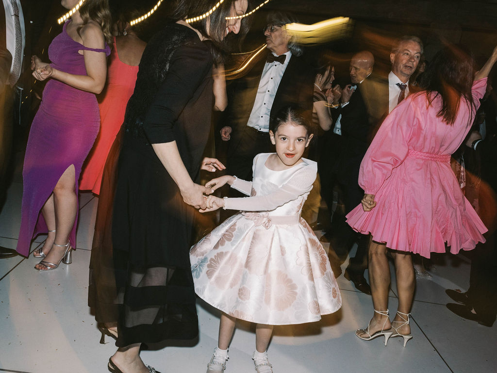 Young girl dancing with guests at DC Ranch wedding reception