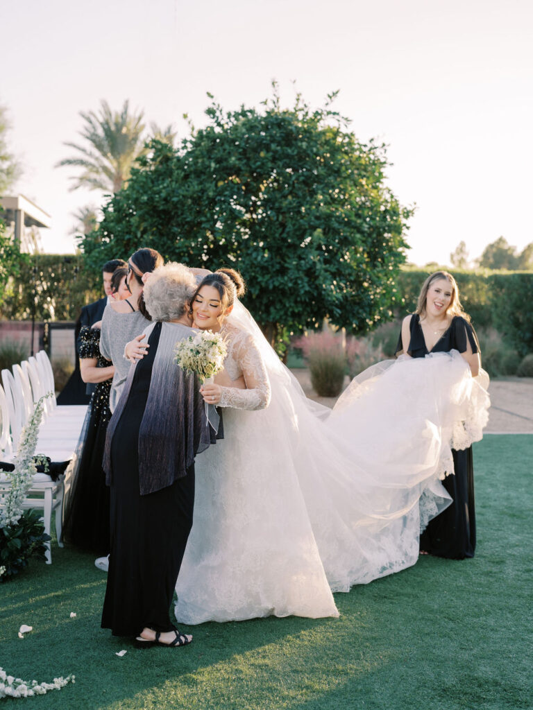 Bride hugging a guest before wedding ceremony in Arizona.