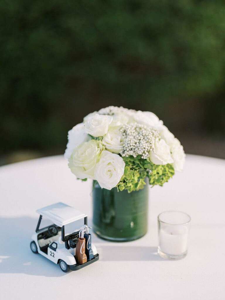 Floral centerpiece with golf cart detail at Silverleaf Masters Golf wedding party