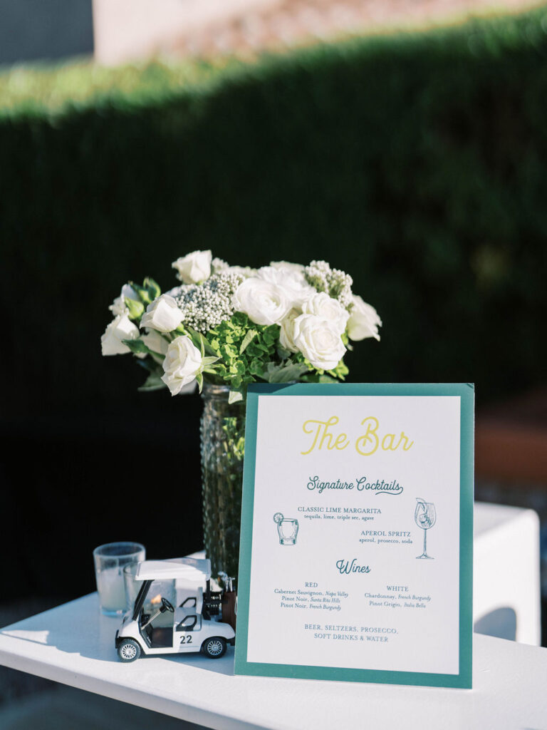 Masters Golf bar menu and floral centerpiece at Silverleaf wedding welcome party