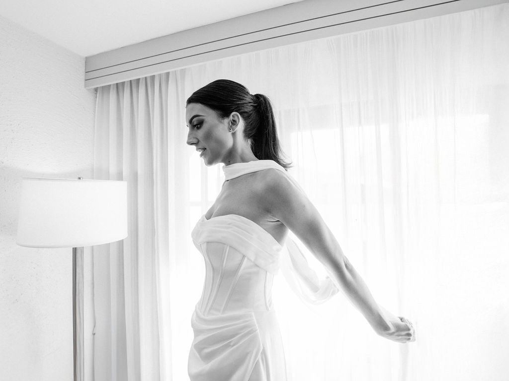 Bride standing near window at Camelback Inn wedding