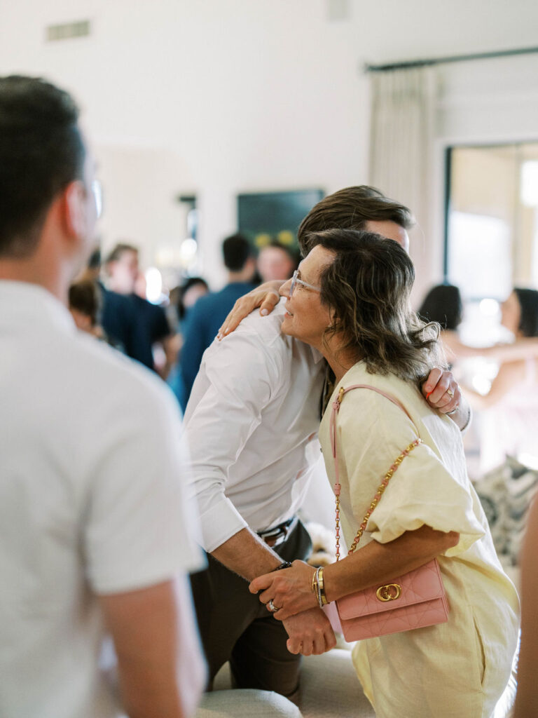 Guests greeting with a cheek kiss at Silverleaf Masters Golf wedding welcome party