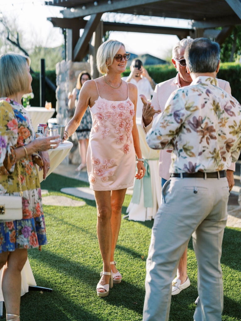 Guest in pink floral dress at Silverleaf Masters Golf wedding welcome party