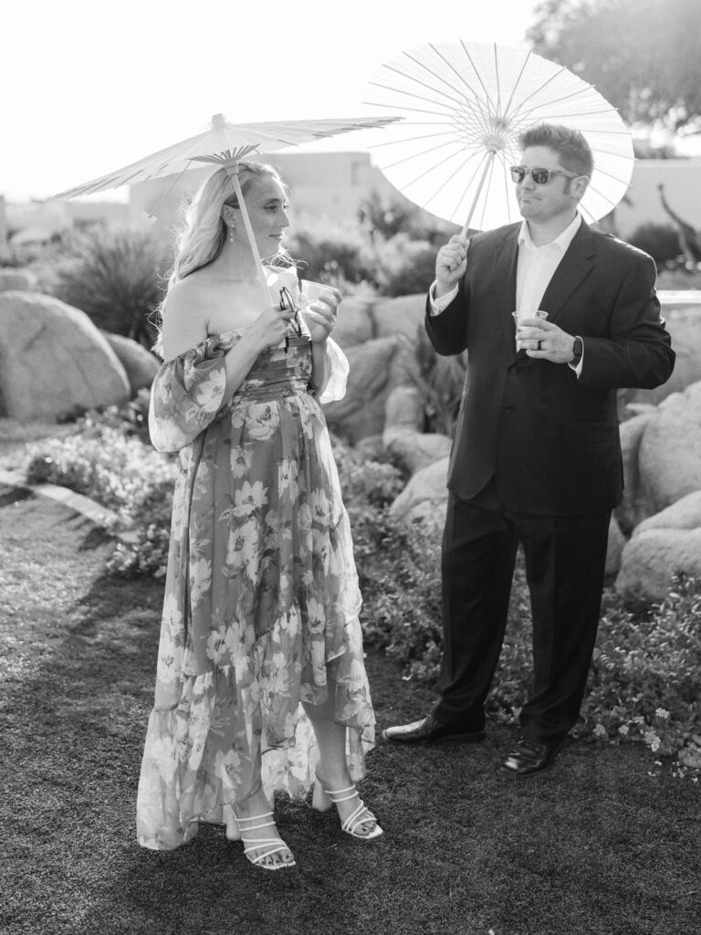 Guests with parasols during Camelback Inn wedding ceremony
