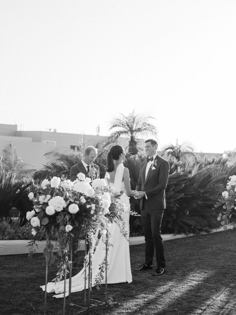 Outdoor wedding ceremony with floral arch at Camelback Inn