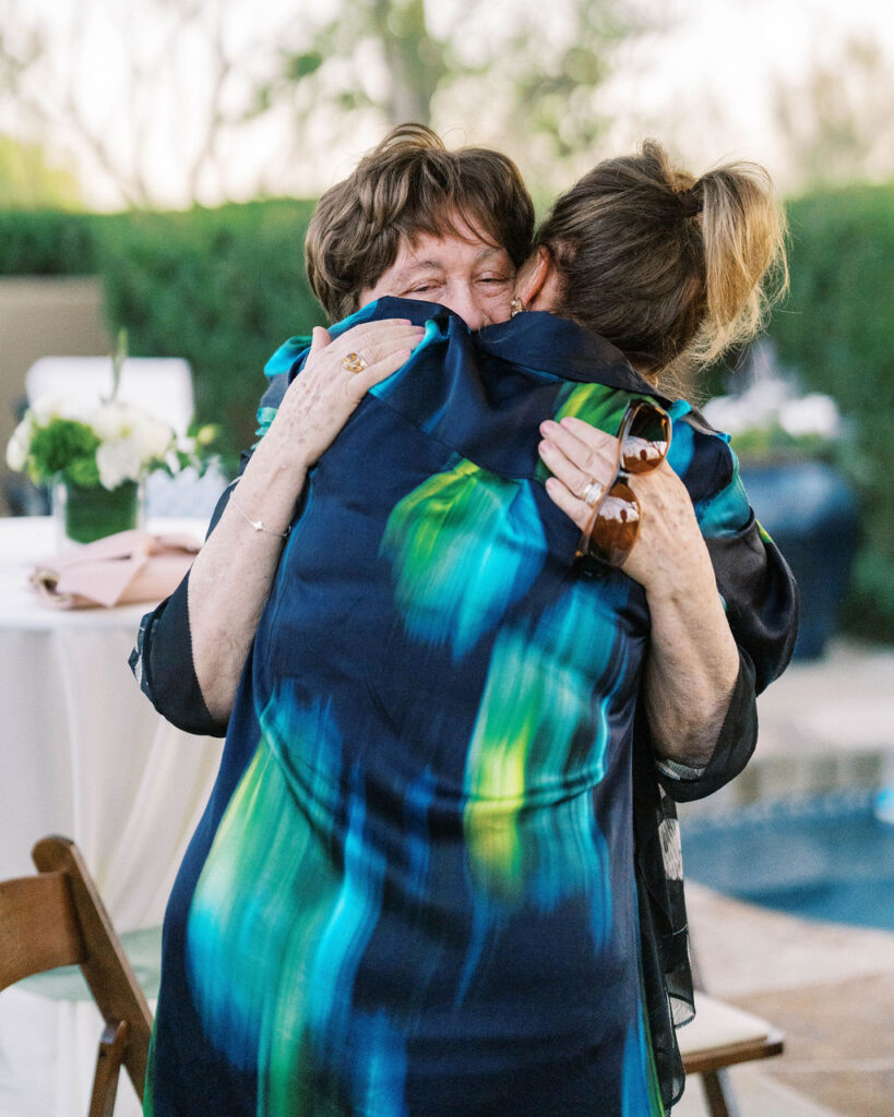 Emotional hug at Silverleaf Masters Golf wedding welcome party in Arizona