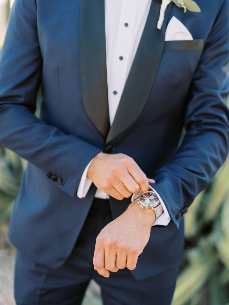 Groom wedding detail adjusting watch at Camelback Inn wedding