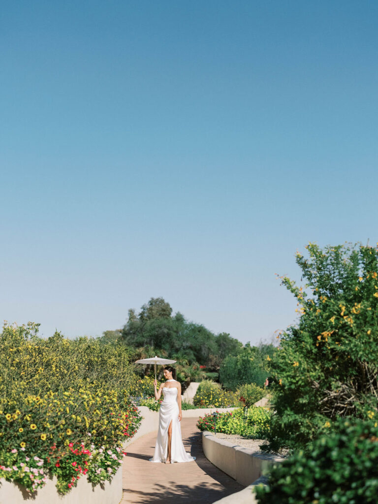 Bride walking in Camelback Inn garden captured by Arizona wedding photographer