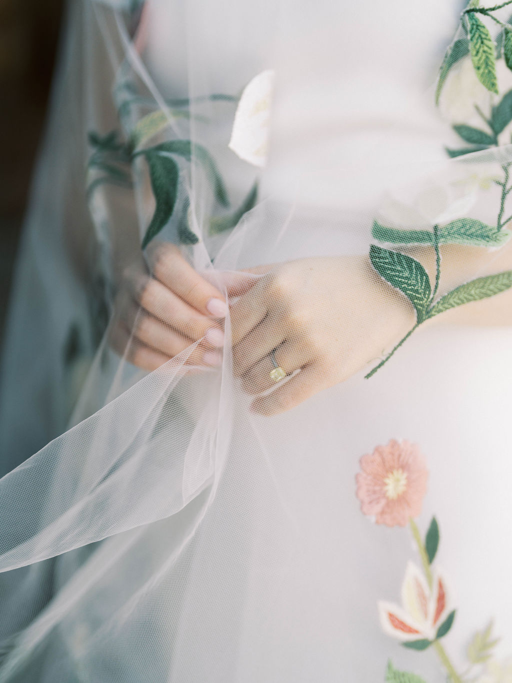 Close-up of bride’s hand with floral veil detail at DC Ranch