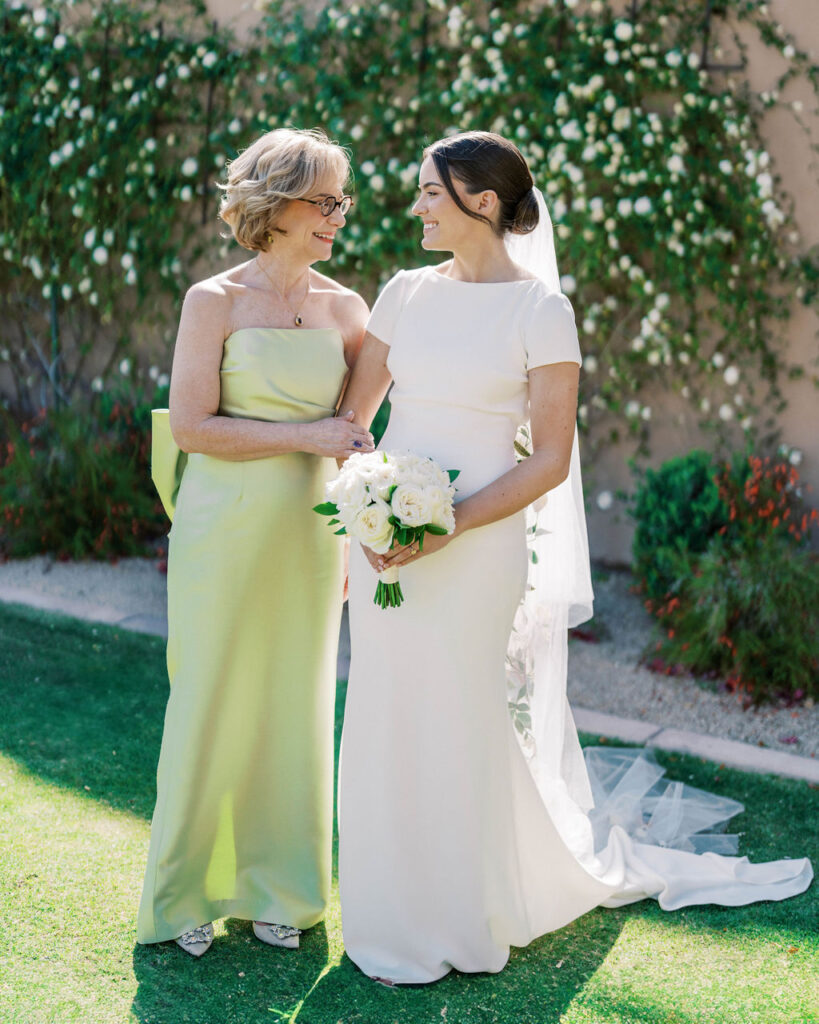 Bride standing with family member in green dress at DC Ranch wedding