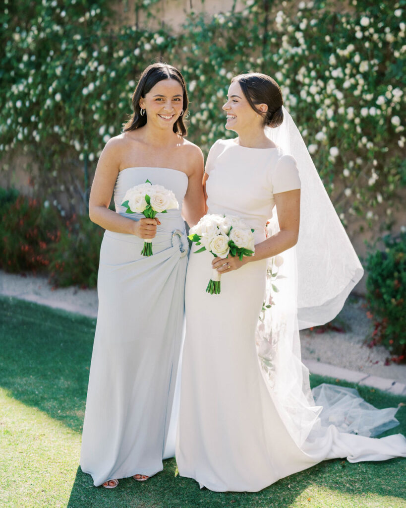 Bride and bridesmaid smiling together at DC Ranch wedding
