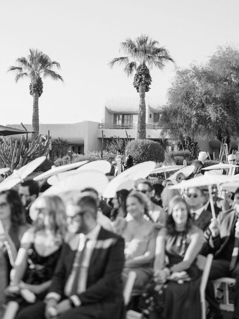 Camelback Inn wedding ceremony with parasols and guests