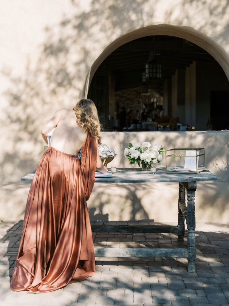 Wedding guest arranging table details at DC Ranch