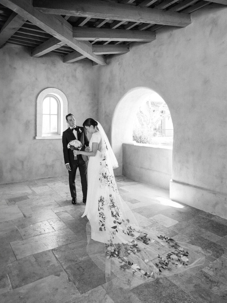 Bride and groom framed by stone arch at DC Ranch wedding