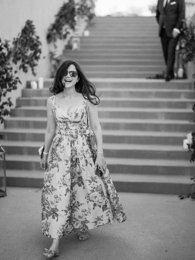 Wedding guest in floral gown walking down DC Ranch steps