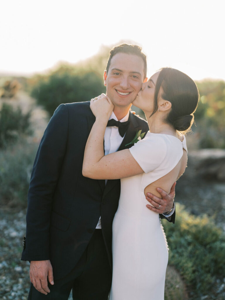 Artistic film-inspired wedding photo of couple and bouquet