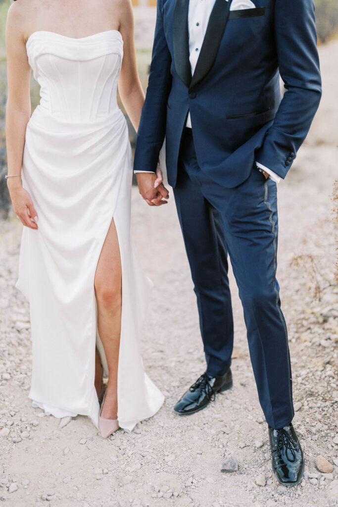 Bride and groom holding hands in Camelback Inn desert garden