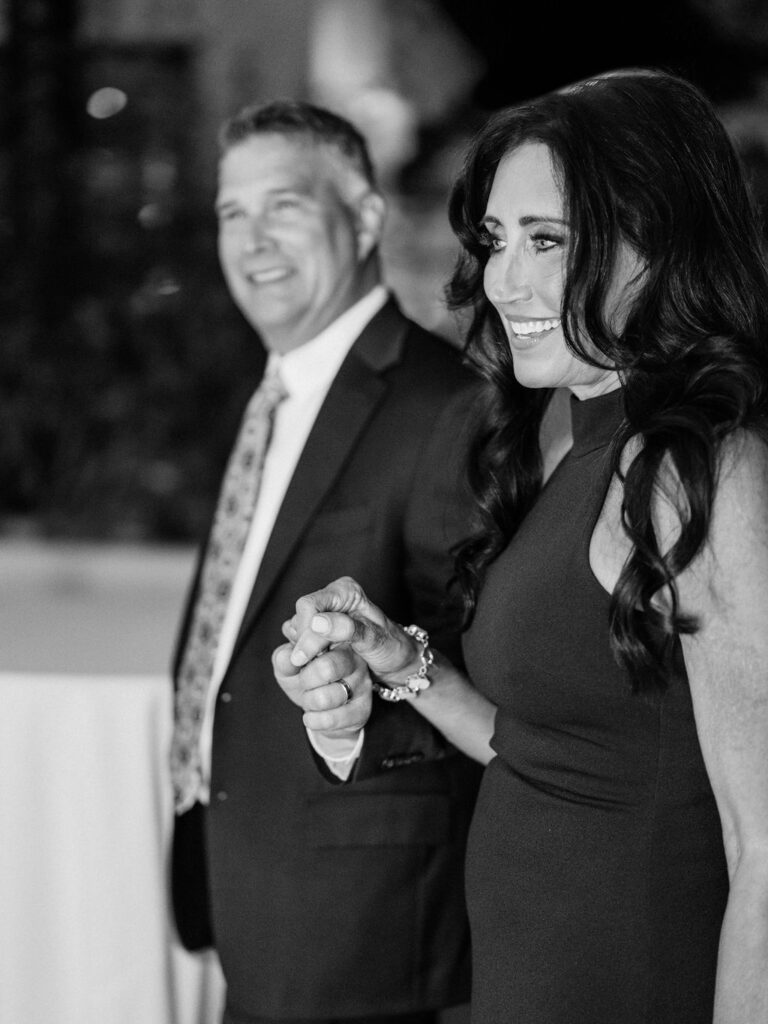 Black and white candid of guests hugging at El Chorro dinner