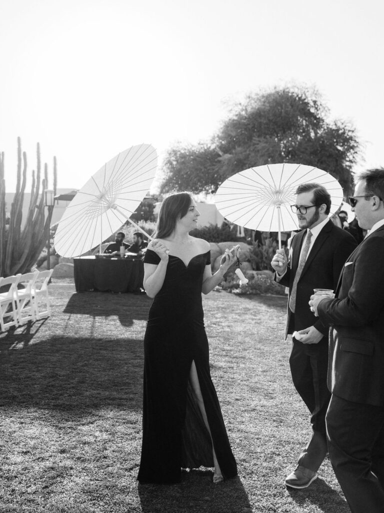 Guests with parasols during Camelback Inn outdoor wedding