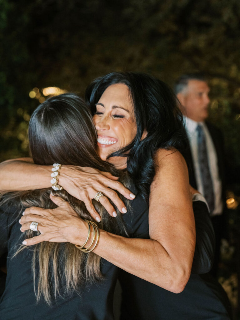 Guests hugging during El Chorro dinner celebration