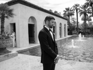 Groom stands waiting by fountain at Paradise Valley Country Club.