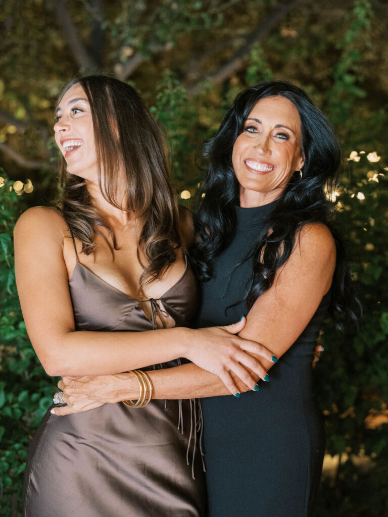 Two women sharing a joyful moment at El Chorro dinner
